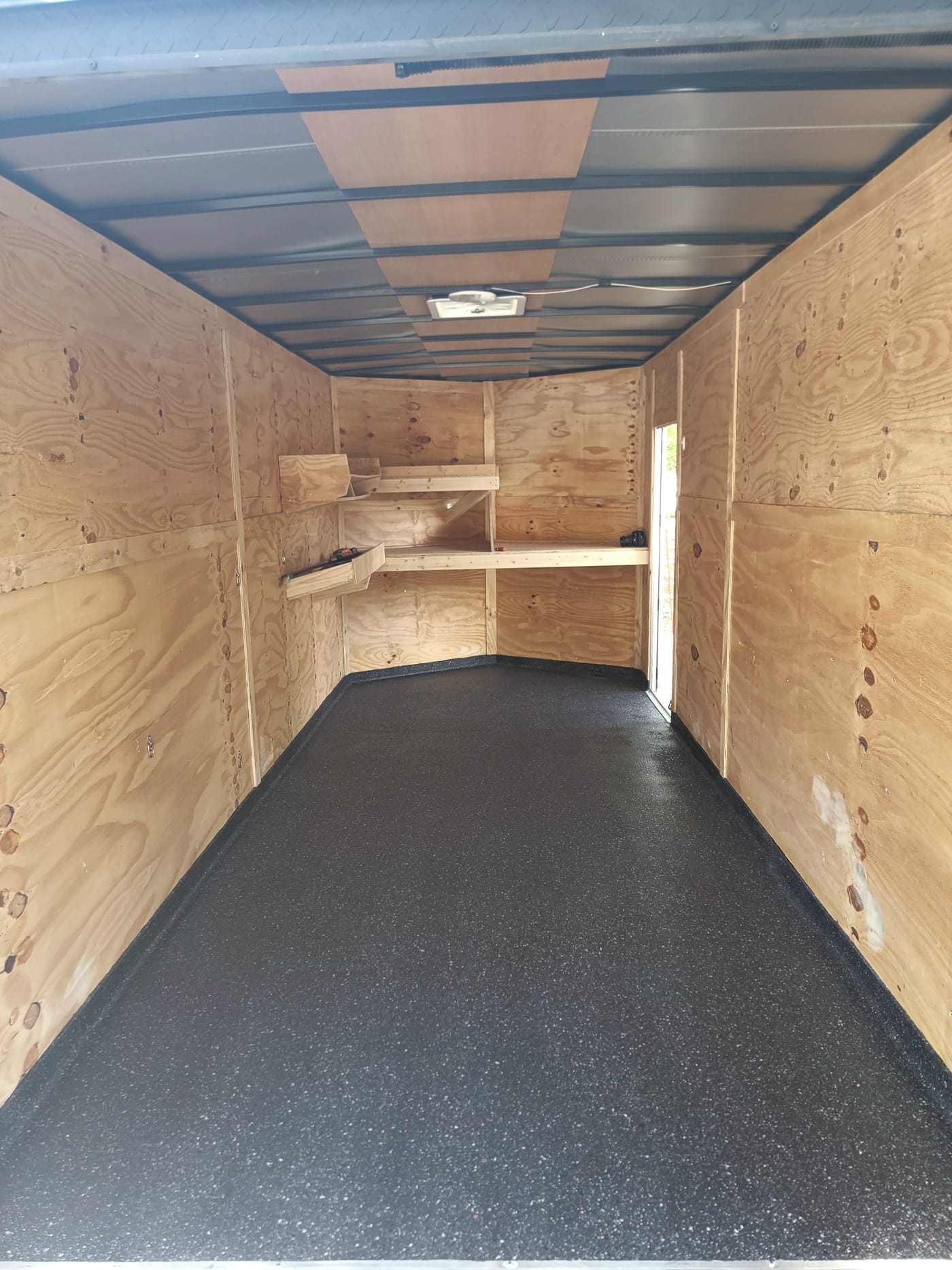 Trailer floor after dark protective coating installation.