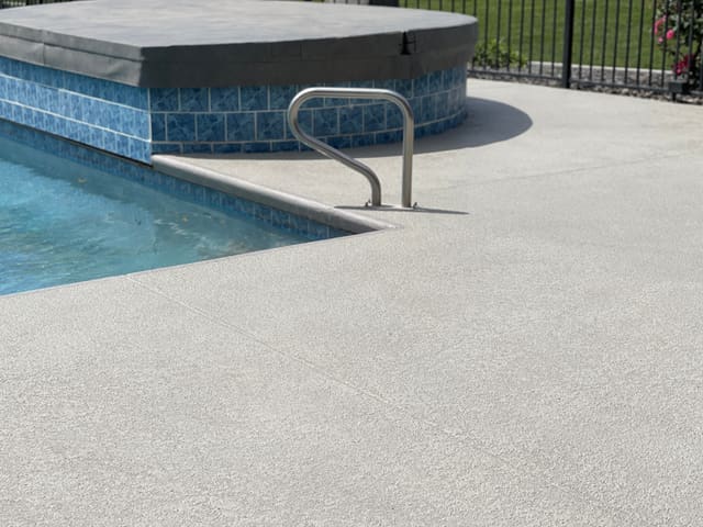 Outdoor concrete surface finished with a durable decorative coating.