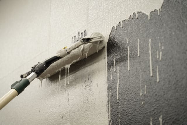 Textured concrete repair area prepared and coated for a finished surface.