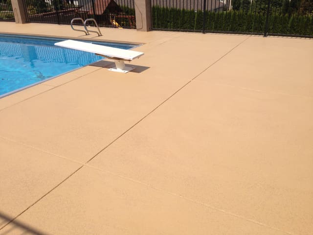 Pool deck concrete surface finished with a light outdoor coating.