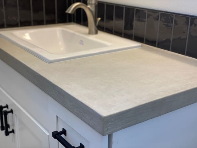Bathroom vanity countertop with a light decorative epoxy coating.
