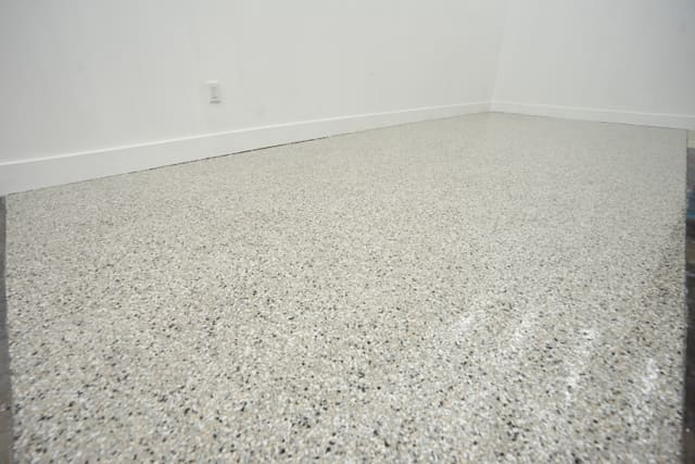 Light decorative flake floor coating installed in a clean interior space.