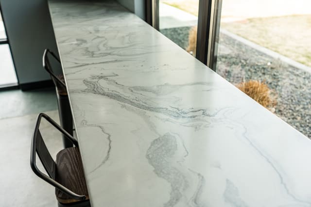 Bright breakfast countertop with a light gray decorative epoxy finish.