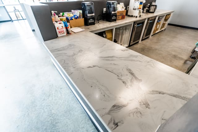 Long bar countertop with a light stone-look epoxy coating.