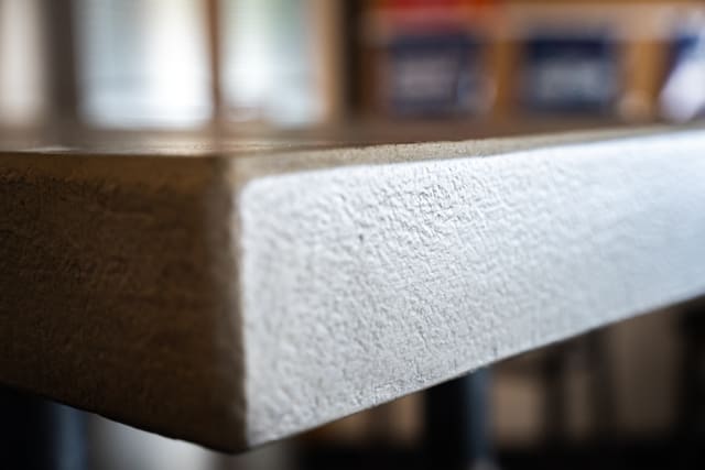 Close detail of a coated countertop edge with a textured finish.
