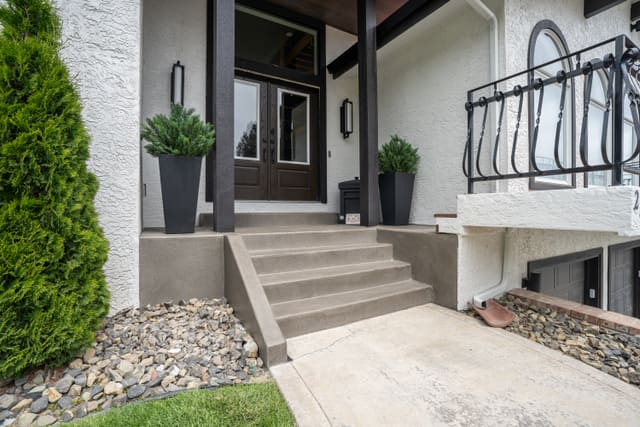 Front steps and entry concrete finished with a light outdoor coating.