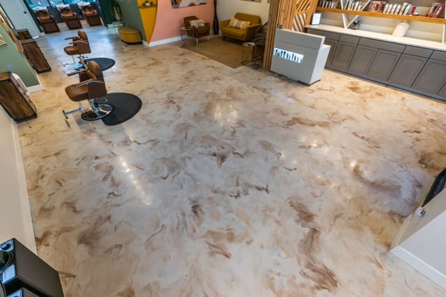 Indoor floor with a glossy cream and gold metallic epoxy finish.