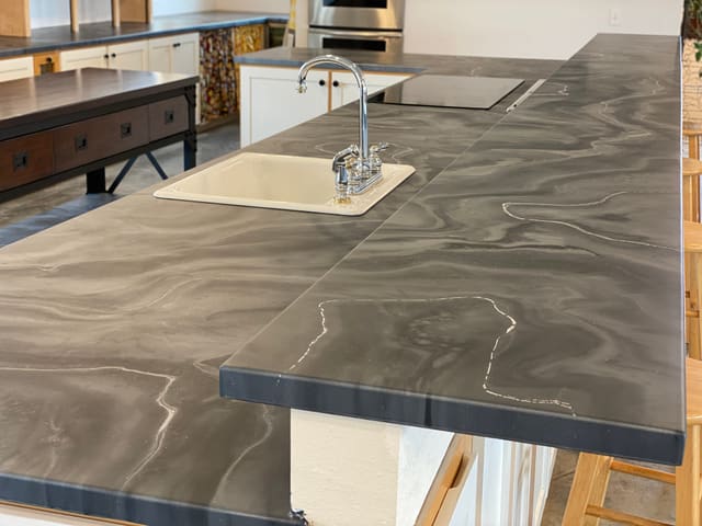 Gray epoxy countertop coating installed around a sink and island.
