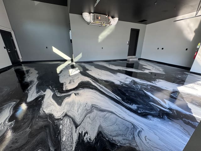 Black marbled epoxy floor with glossy white movement.