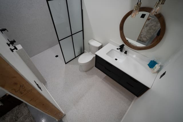 Bathroom shower coating system with a smooth light decorative finish.