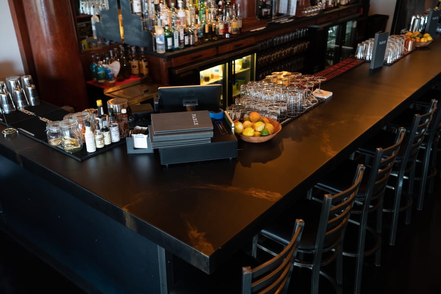 Black epoxy countertop coating installed across a bar surface.