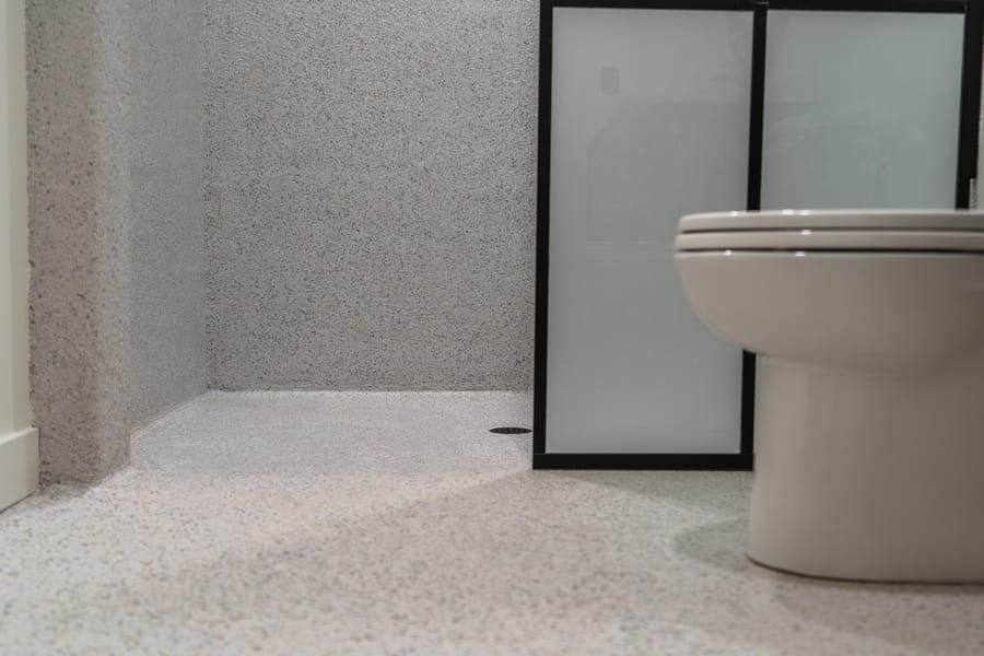 Light decorative shower coating installed around a bathroom fixture.
