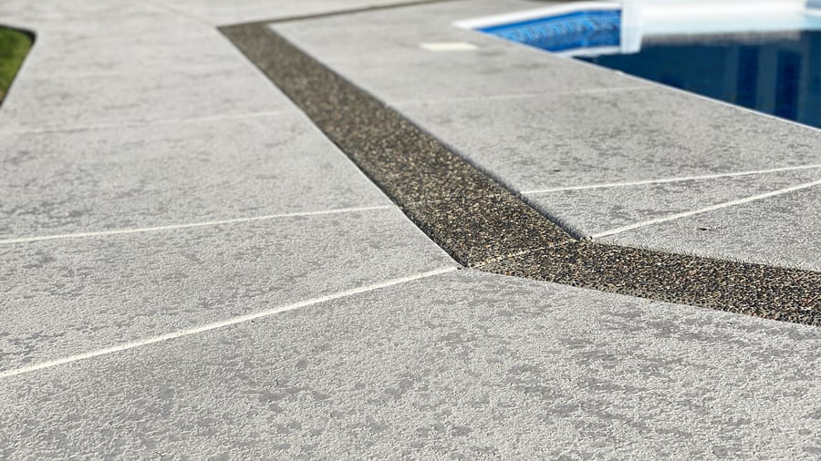 Textured deck coating sample with decorative inlay detail.